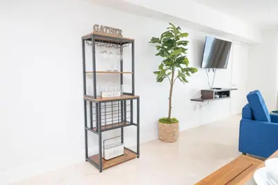 a living room with a book shelf and a plant at 2Bed 2 Bath Airbnb Friendly building with Pool, Hot Tub, and Gym in Miami