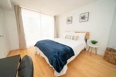 a bedroom with a large bed and a large window at 2Bed 2 Bath Airbnb Friendly building with Pool, Hot Tub, and Gym in Miami