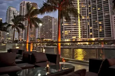 a restaurant with palm trees and a view of a city at 2 Bedroom, 2 Bathroom plus Den Brickell Condo Pool, Hot Tub, and Gym in Miami