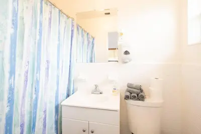 a bathroom with a sink and a toilet and a mirror at Modern 5 Bedroom Miami Home 15 Min to the Beach in Miami