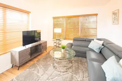 a living room with a couch and a television at Modern 5 Bedroom Miami Home 15 Min to the Beach in Miami