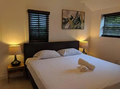 a bedroom with a large white bed with two lamps at 3 Bedroom Miami Home 15 Minutes to the Beach in Miami