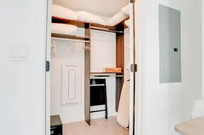 a room with a door open to a room with a bed at Modern and newly built studio with Pool, Gym, and Restaurant access in Miami