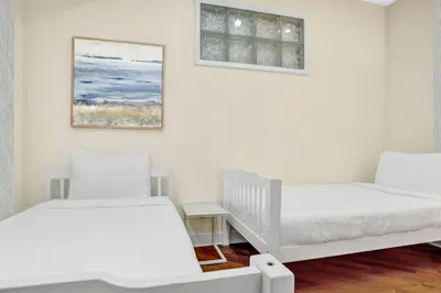 a bedroom with two beds and a window at Lux 2BR Condo in Ocean Reserve with Pools and Tennis Courts in Miami Beach