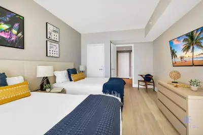 a hotel room with two beds and a desk at Ocean View Balcony, Beachfront Resort, Pools, Gym in Hollywood