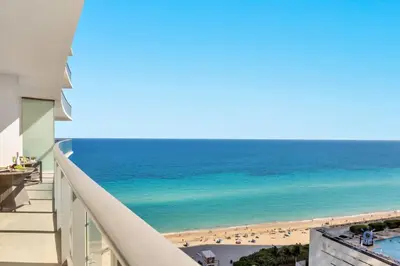 a view of the beach from the balcony of a building at Ocean View Balcony, Beachfront Resort, Pools, Gym in Hollywood