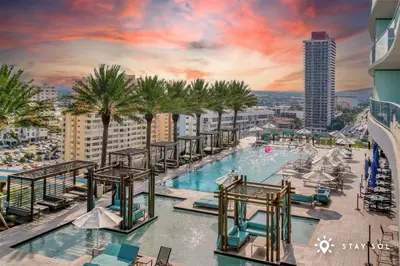 a pool on the top of a building with palm trees at Ocean View Balcony, Beachfront Resort, Pools, Gym in Hollywood