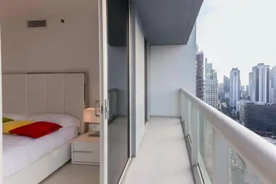 a bedroom with a bed and a balcony with a city at Amazing unit Miami Brickell with Sea & City View in Miami