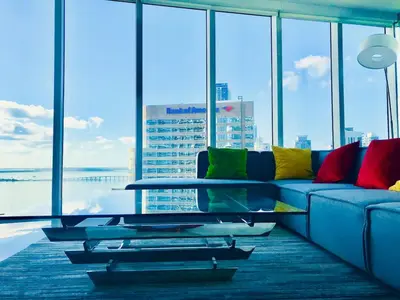 a living room with a couch with colorful pillows at Amazing unit Miami Brickell with Sea & City View in Miami