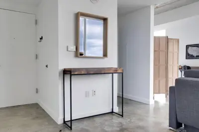 a room with a table and a mirror on the wall at Sun-Splashed 1BR Condo unit in DWTN Miami with WFH in Miami