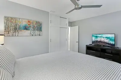 a white bedroom with a bed and a ceiling fan at Modern 2BRHouse in Wilton Manors with a Heated Pool and KING Bed in Fort Lauderdale