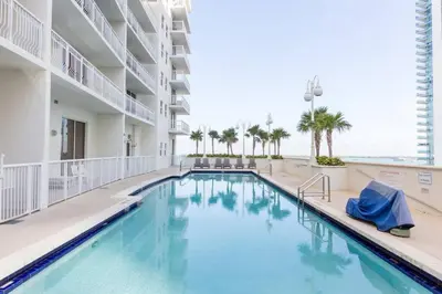 a swimming pool in a hotel with the ocean in the background at Ocean and City Views Lux Miami Brickell Sleeps 5 in Miami