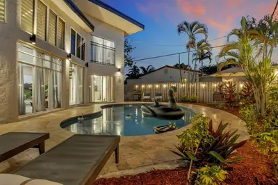 a swimming pool in the backyard of a house at Stunning 2 Story Villa with Pool in Fort Lauderdale