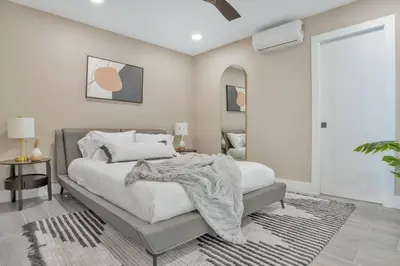 a bedroom with a large bed and a mirror at Stunning 2 Story Villa with Pool in Fort Lauderdale