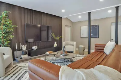 a living room with a couch and a tv at Stunning 2 Story Villa with Pool in Fort Lauderdale