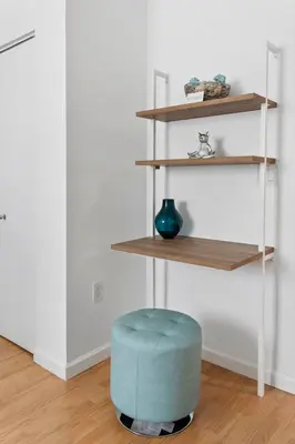 a blue ottoman sitting in a room with shelves at Waterfront Luxury 2-Bedroom Condo Sunny Isles Beach in Miami Beach