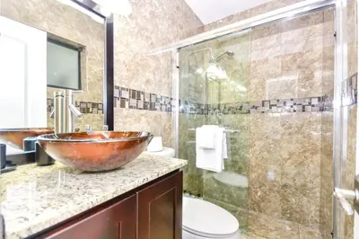 a bathroom with a copper bowl sink and a shower at Five Bedroom Villa With POOL In Highland Lakes Near Aventura Mall in Miami