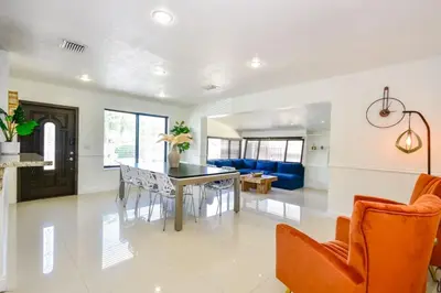 a dining room and living room with a table and chairs at Five Bedroom Villa With POOL In Highland Lakes Near Aventura Mall in Miami
