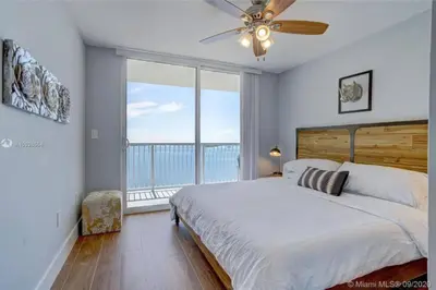 a bedroom with a bed and a large window at 3BR Airbnb Friendly Condo with Ocean View and Balcony in Miami
