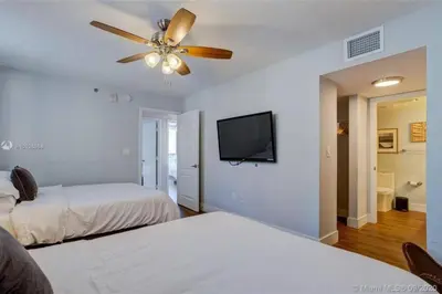 a bedroom with two beds and a ceiling fan at 3BR Airbnb Friendly Condo with Ocean View and Balcony in Miami