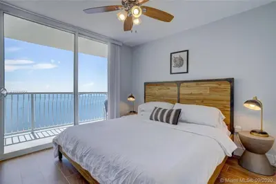 a bedroom with a large bed and a large window at 3BR Airbnb Friendly Condo with Ocean View and Balcony in Miami