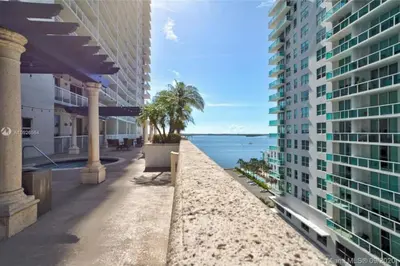 a view of the beach between two buildings at 3BR Airbnb Friendly Condo with Ocean View and Balcony in Miami