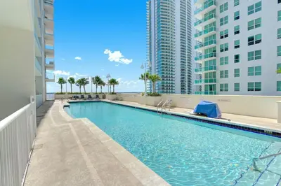 a swimming pool in a building with tall buildings at Penthouse with Ocean and City Views in Lux Miami Brickell Sleeps 4 in Miami