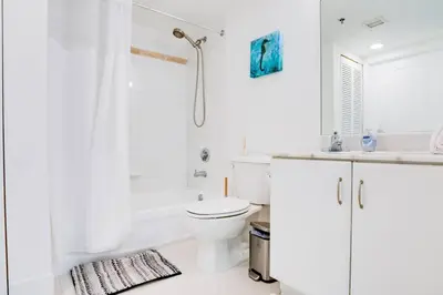 a white bathroom with a toilet and a shower at Penthouse with Ocean and City Views in Lux Miami Brickell Sleeps 4 in Miami