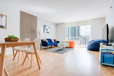 a living room with a table and a blue couch at Ocean and City Views Lux Miami Brickell Condo Sleeps 4, King Bed in Miami