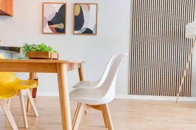 a dining room with a white chair and a wooden table at Ocean and City Views Lux Miami Brickell Condo Sleeps 4, King Bed in Miami