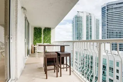 a balcony with a table and two chairs on it at Ocean and City Views Lux Miami Brickell Condo Sleeps 4, King Bed in Miami