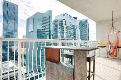 a balcony with a table and views of the city at Ocean and City Views Lux Miami Brickell Condo Sleeps 4, King Bed in Miami