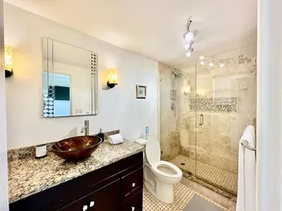 a bathroom with a sink and a toilet and a shower at Luxury Beachfront Family-Friendly Condo in Hollywood