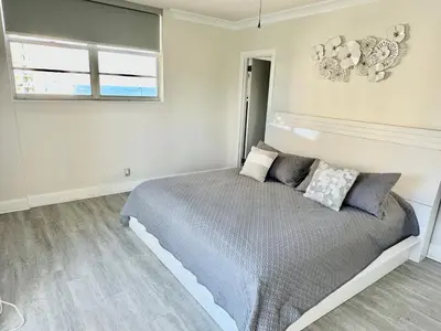 a bedroom with a bed and a window at Luxury Beachfront Family-Friendly Condo in Hollywood