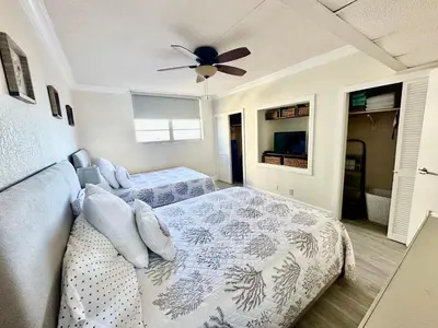 a bedroom with two beds and a ceiling fan at Luxury Beachfront Family-Friendly Condo in Hollywood