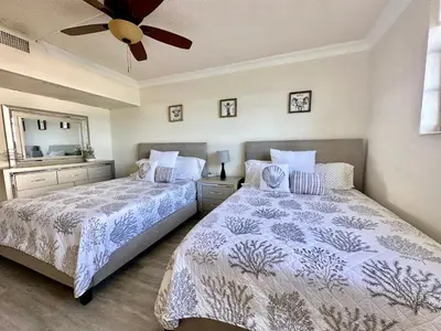 a bedroom with two beds and a ceiling fan at Luxury Beachfront Family-Friendly Condo in Hollywood