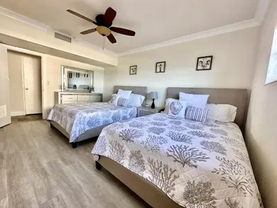 a bedroom with two beds and a ceiling fan at Luxury Beachfront Family-Friendly Condo in Hollywood