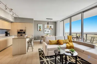 a living room with a couch and a kitchen at Amazing Pools - Bay View - Parking Included in Hollywood