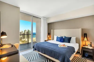 a bedroom with a large bed and a large window at High Floor with Stunning Views, Amazing Pools in Hollywood