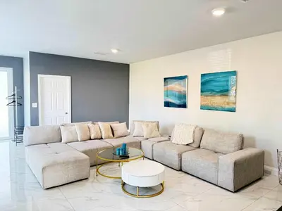 a living room with a couch and a table at Modern Miami Retreat, Hot Tub and Gazebo Oasis in Miami