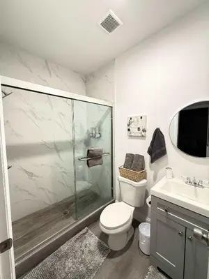 a bathroom with a shower and a toilet and a sink at Modern Miami Retreat, Hot Tub and Gazebo Oasis in Miami