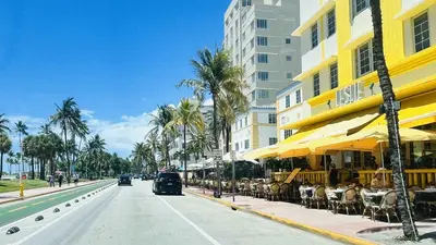 a street with tables and umbrellas on a city street at Sky-High oasis heated Pool & Gym Miami Skyline Vista in Miami