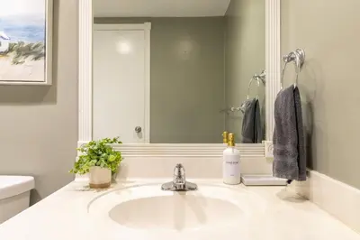 a bathroom with a sink and a mirror at Beachfront 1-Bedroom Apartment with Ocean View, Pool and Gym in Hollywood Beach in Hollywood