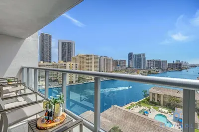an apartment balcony with a view of the ocean at Infinite View Balcony with Pool, Gym and Near Beach in Hallandale Beach