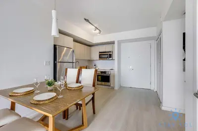 a kitchen and dining room with a table and chairs at Infinite View Balcony with Pool, Gym and Near Beach in Hallandale Beach