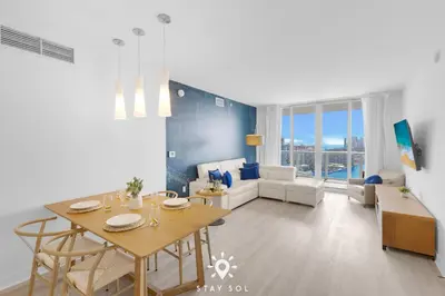 a living room with a table and a dining room at Balcony with View, Pool, Gym, Near Beach in Hallandale Beach