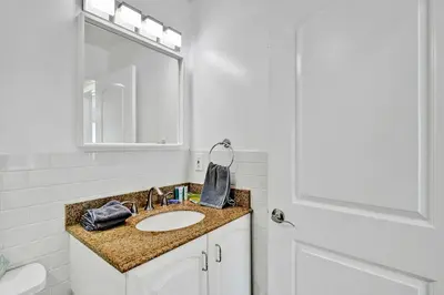 a bathroom with a sink and a mirror at Deluxe Home Heated Pool & Jetted Tub near Beach in Dania Beach