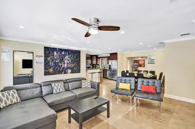 a living room with a couch and a ceiling fan at Deluxe Home Heated Pool & Jetted Tub near Beach in Dania Beach
