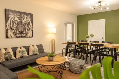 a living room with a couch and a table at Oia House Brickell Beach 10 minutes Pool Location in Miami