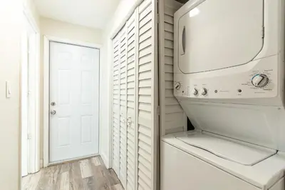 a white laundry room with a washer and dryer at Oia House Brickell Beach 10 minutes Pool Location in Miami